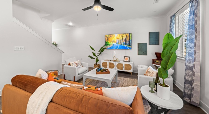 a living room with a couch and a fan