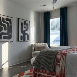 a bedroom with a large window