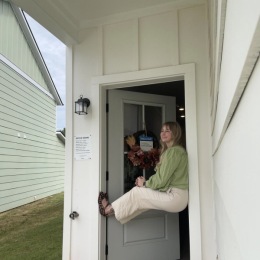a woman posing in a doorway