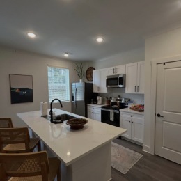 a kitchen with white cabinets