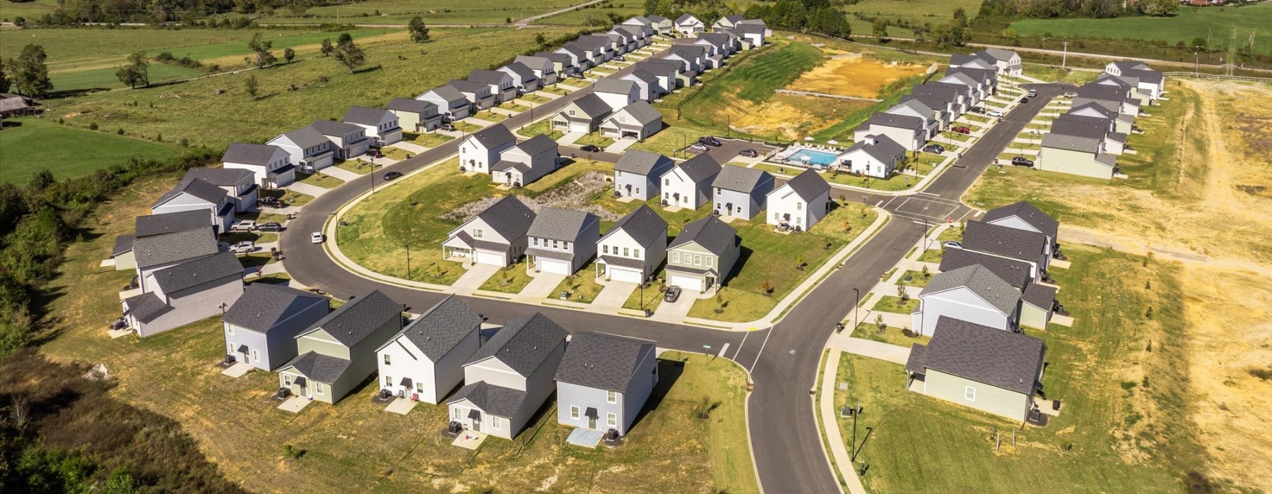 a group of houses in a field